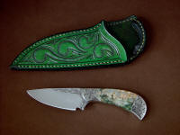 "Bootes ST" obverse side view in hand-engraved 440C high chromium stainless steel blade, hand-engraved 304 stainless steel bolsters, Green Orbicular Jasper gemstone handle, hand-carved leather sheath