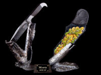 "Morta" in twist damascus welded blade, hand-engraved 304 stainless steel bolsters, ancient Bog Oak handle, hand-carved, hand-dyed leather sheath, hand-cast bronze stands